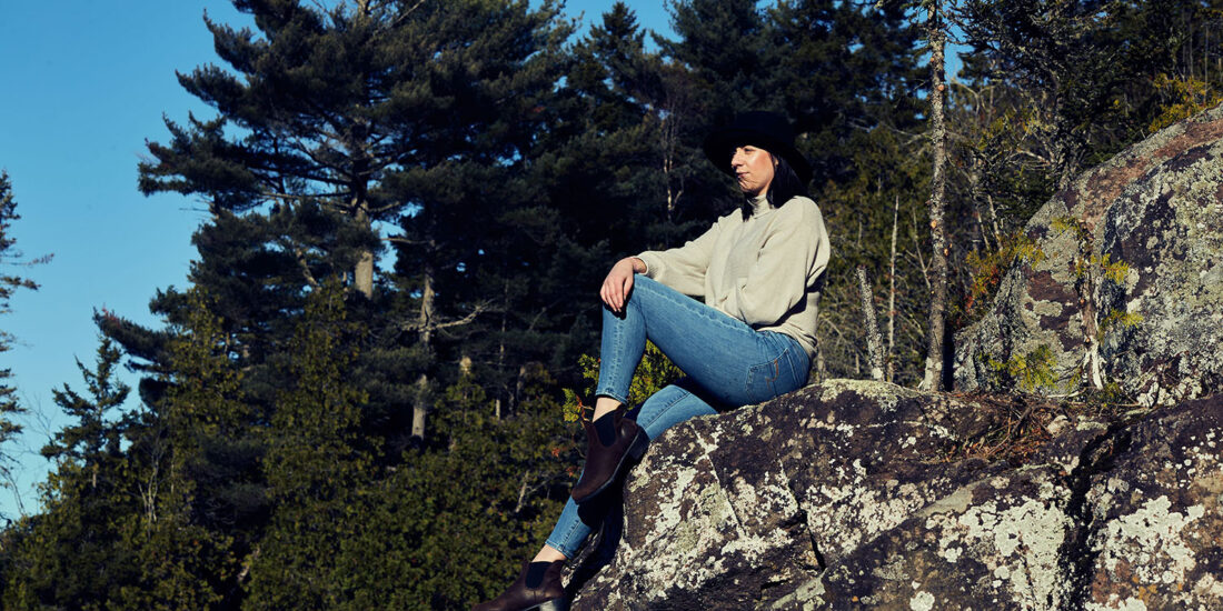 Female sitting on the edge of a cliff